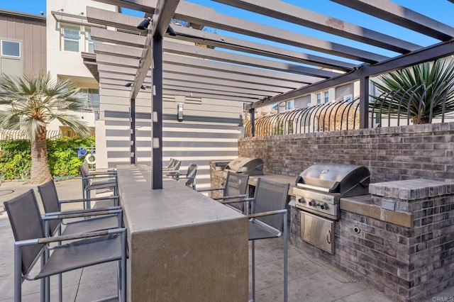 view of patio / terrace with a pergola, area for grilling, and exterior kitchen