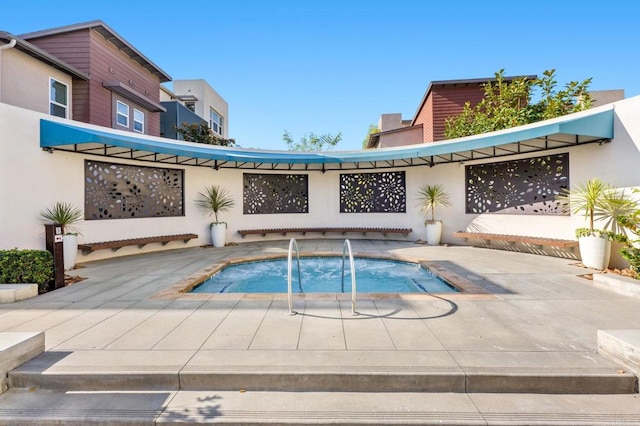 view of pool with a hot tub