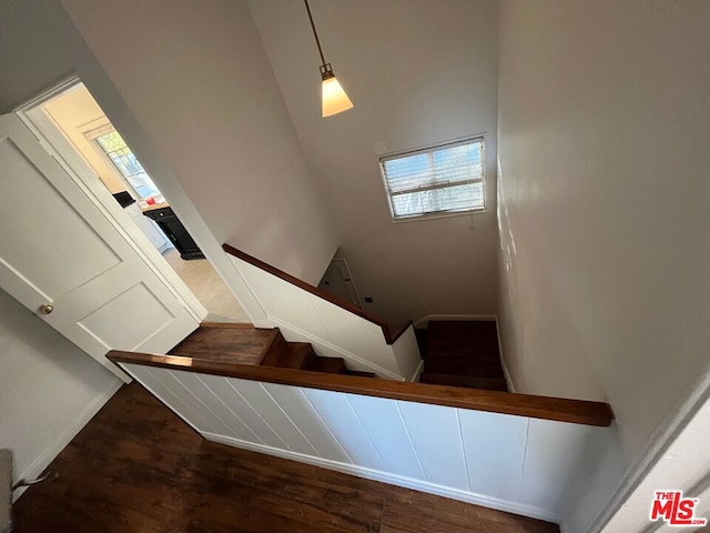 stairway with hardwood / wood-style floors