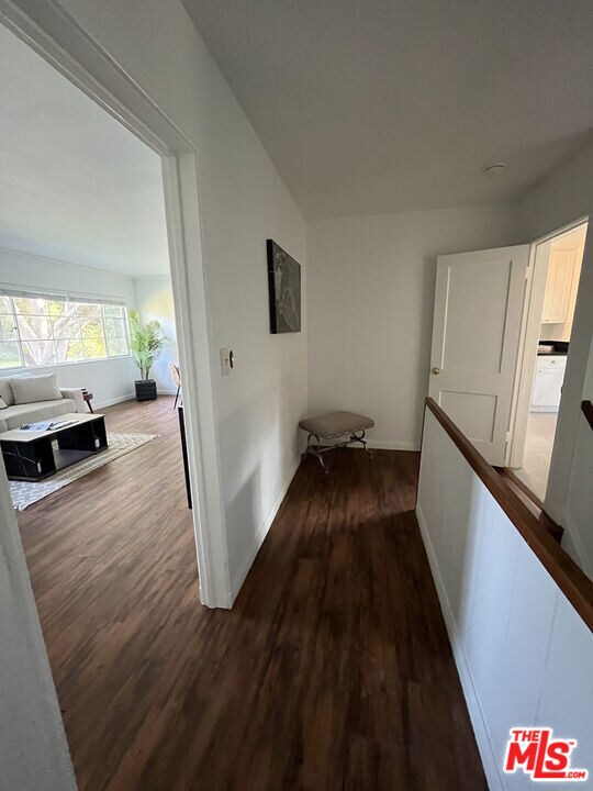 hallway with dark wood-type flooring