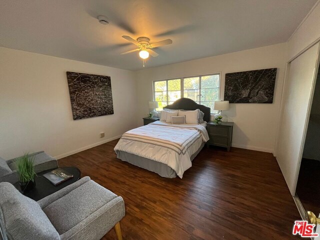 bedroom featuring dark hardwood / wood-style flooring and ceiling fan