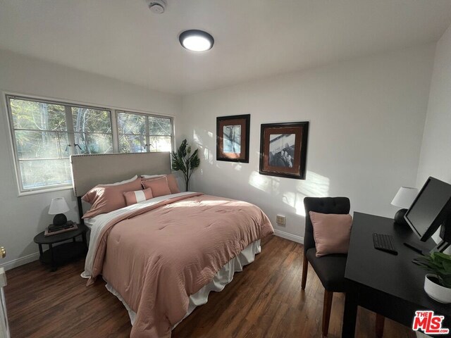 bedroom featuring dark hardwood / wood-style flooring