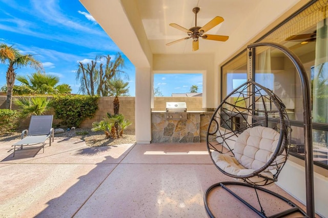 view of patio featuring area for grilling, ceiling fan, and a grill