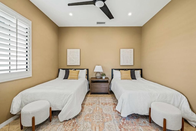 bedroom with multiple windows and ceiling fan