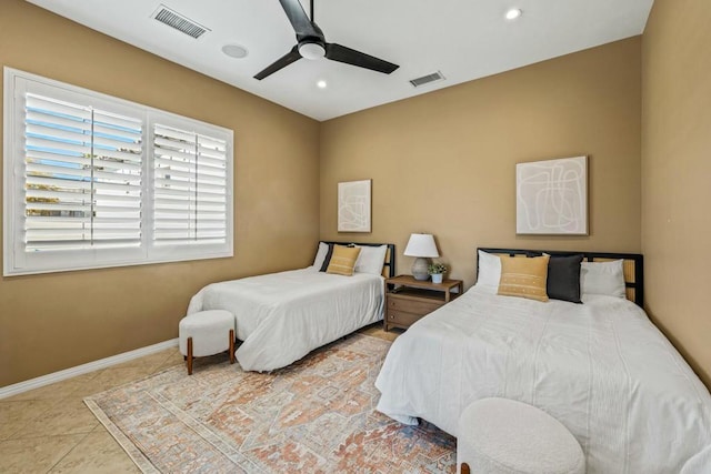 bedroom with ceiling fan and light tile patterned floors