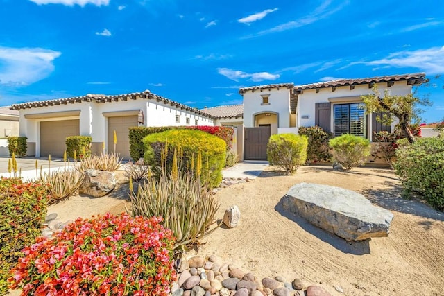 mediterranean / spanish-style home with a garage