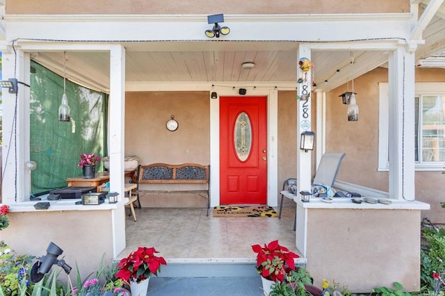 doorway to property featuring covered porch