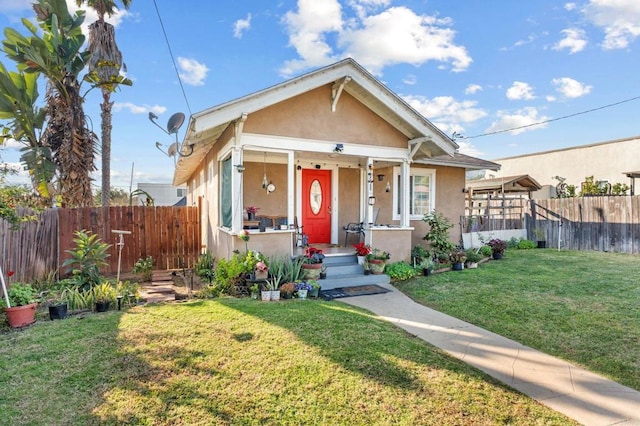 bungalow-style home with a front lawn and a porch