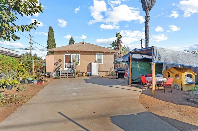 back of property with a patio