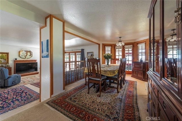 carpeted dining space featuring french doors and a textured ceiling