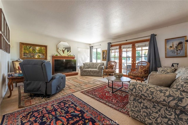 living room featuring french doors, carpet, and a textured ceiling