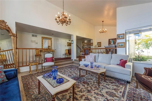 living room with stairs, high vaulted ceiling, visible vents, and an inviting chandelier