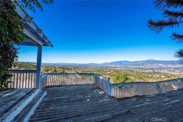 wooden terrace featuring a mountain view