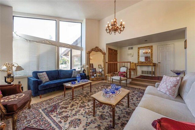 living room with a high ceiling and an inviting chandelier