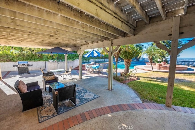 view of patio with a grill, a fenced in pool, and fence