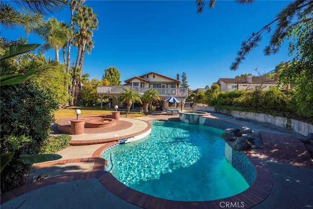 view of pool featuring an in ground hot tub and a patio area