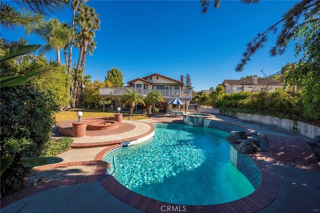 view of swimming pool featuring a patio and a pool with connected hot tub