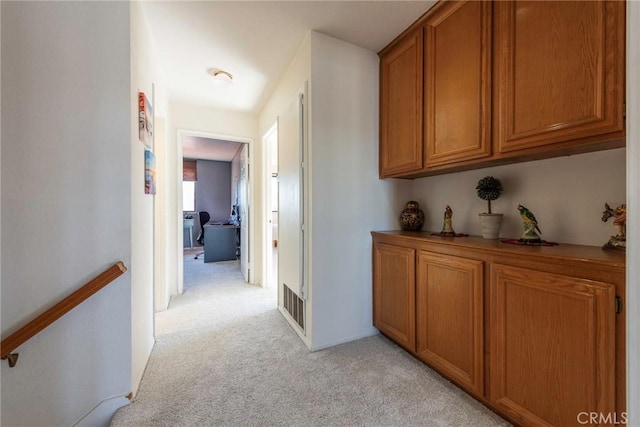 hallway with light colored carpet