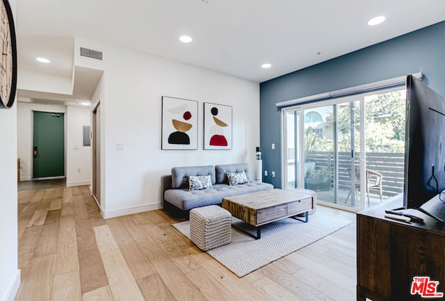 bedroom featuring access to exterior and light hardwood / wood-style flooring