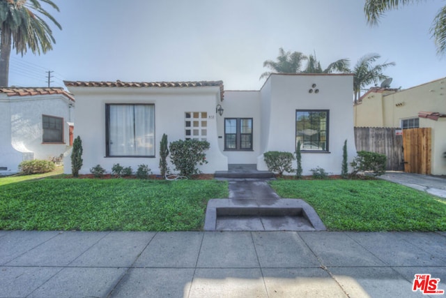 mediterranean / spanish-style house featuring a front lawn