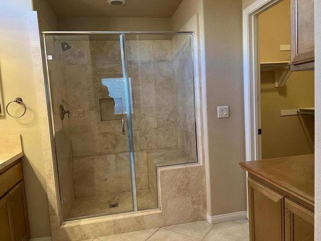 bathroom featuring vanity, a shower with door, and tile patterned floors