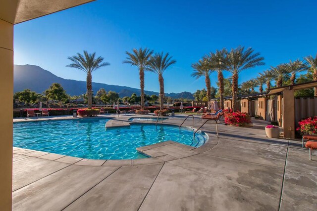 view of pool with a mountain view and a patio area