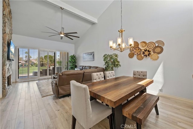 324 Sundance Cir, Palm Desert, CA 92211 - dining space featuring ceiling fan with notable chandelier, light hardwood / wood-style floors, a fireplace, and high vaulted ceiling