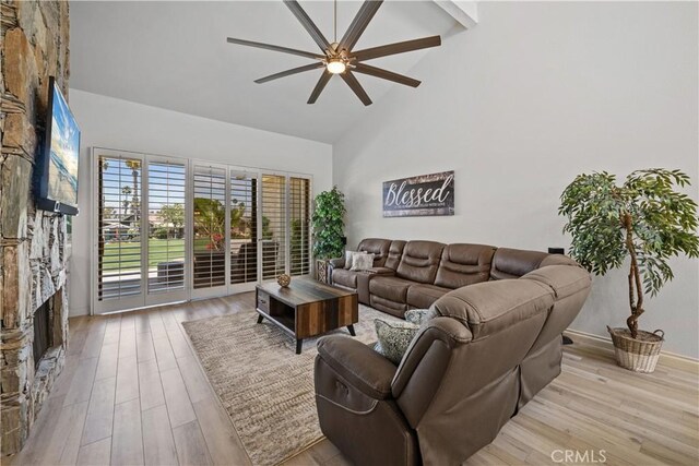324 Sundance Cir, Palm Desert, CA 92211 - living room with ceiling fan, high vaulted ceiling, beamed ceiling, a fireplace, and light hardwood / wood-style floors