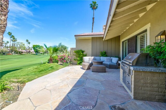 324 Sundance Cir, Palm Desert, CA 92211 - view of patio featuring an outdoor living space, a grill, and exterior kitchen