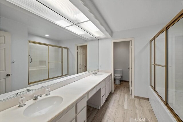 324 Sundance Cir, Palm Desert, CA 92211 - full bathroom with hardwood / wood-style floors, vanity, bath / shower combo with glass door, and toilet