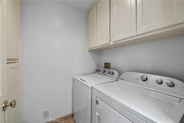 324 Sundance Cir, Palm Desert, CA 92211 - laundry area with washing machine and dryer and cabinets