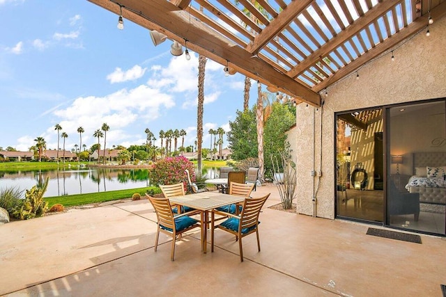 view of patio with a water view and a pergola