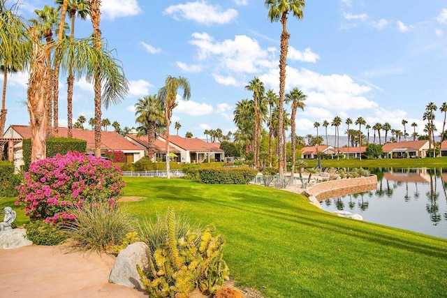 surrounding community featuring a yard and a water view