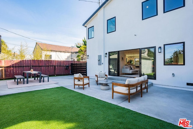 back of property featuring a yard and a patio