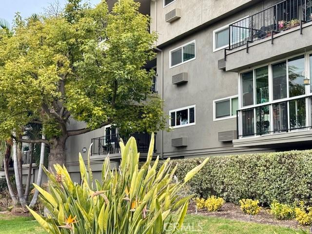 exterior space featuring a wall unit AC and stucco siding