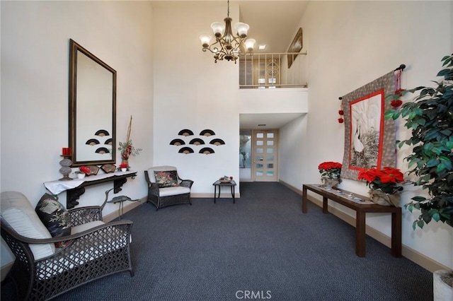 living area with carpet, a towering ceiling, and an inviting chandelier