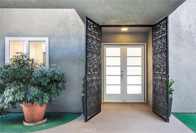 entryway featuring a textured ceiling and french doors