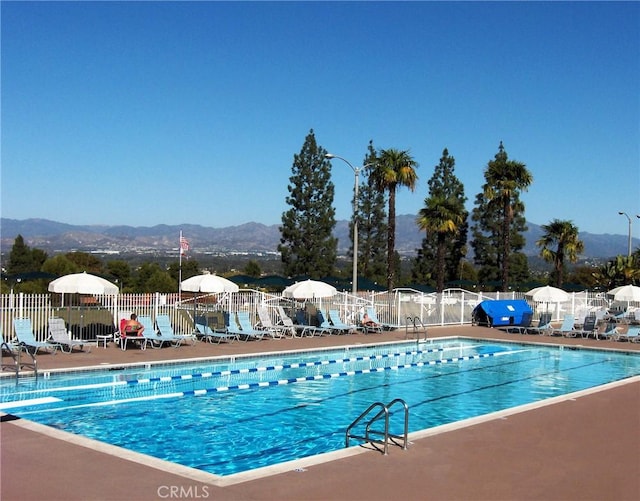 view of swimming pool featuring a mountain view