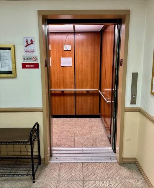 interior details with elevator and baseboards