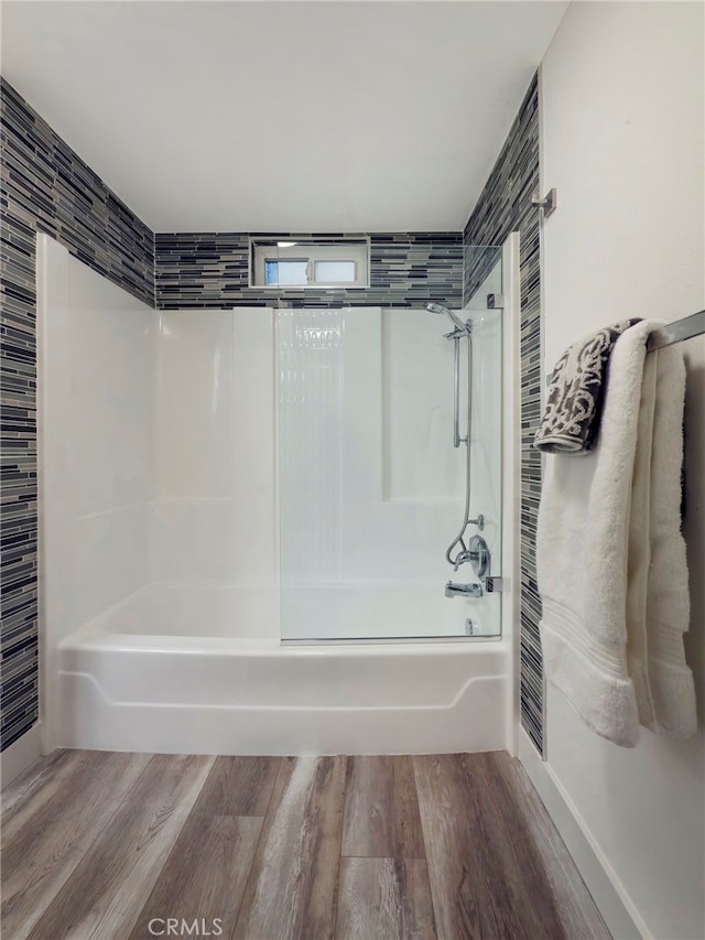 full bathroom featuring bathtub / shower combination and wood finished floors