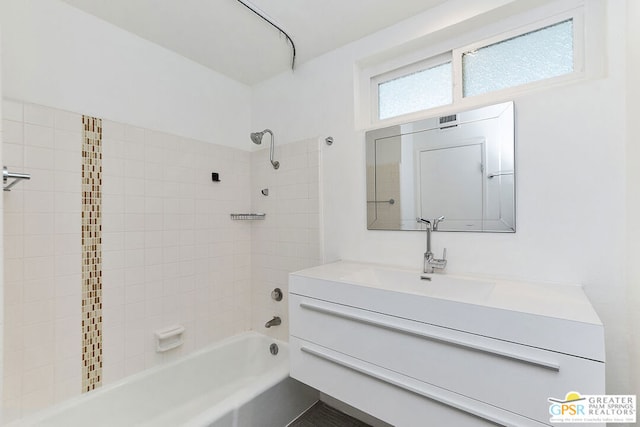 bathroom with vanity and tiled shower / bath combo