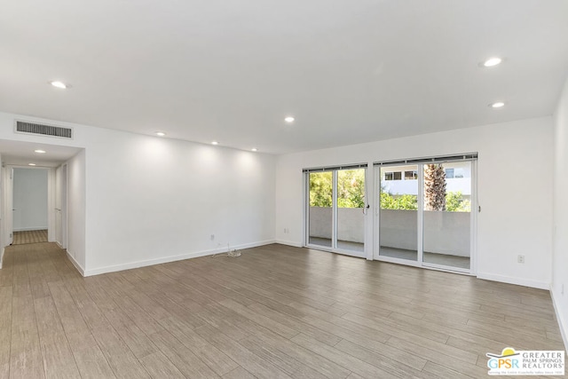 empty room with light hardwood / wood-style floors