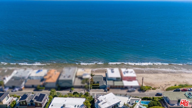 drone / aerial view with a beach view and a water view