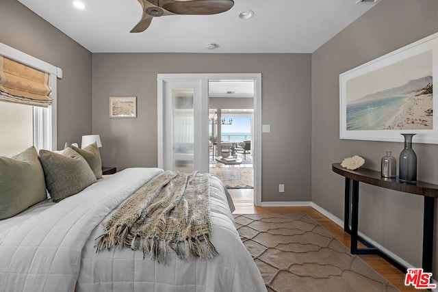 bedroom with hardwood / wood-style floors and ceiling fan