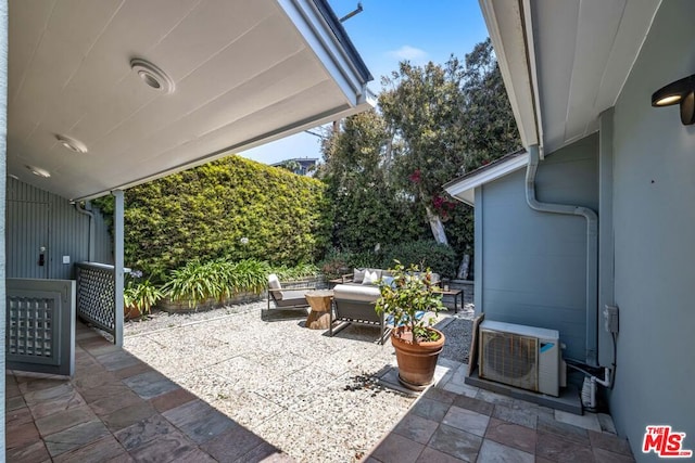 view of patio featuring outdoor lounge area and ac unit