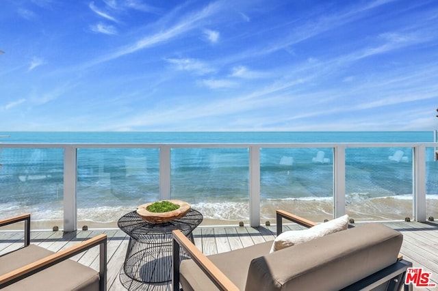 balcony with a view of the beach and a water view