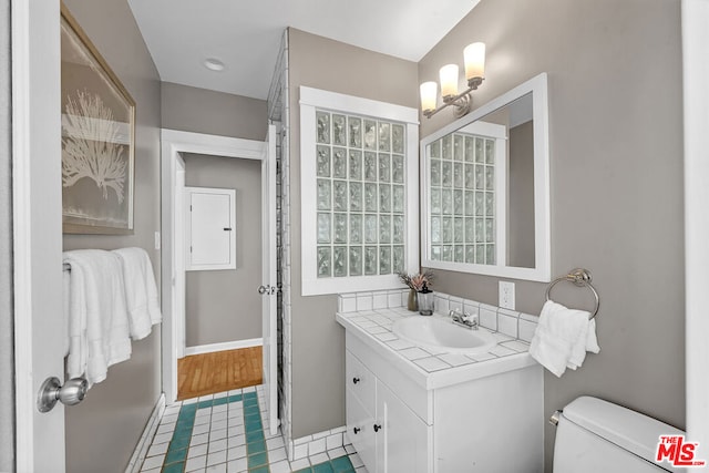 bathroom featuring hardwood / wood-style floors, vanity, and toilet