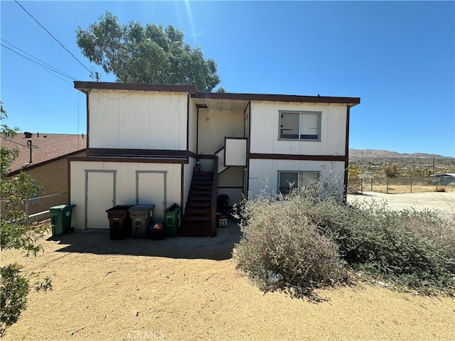 back of house with a mountain view