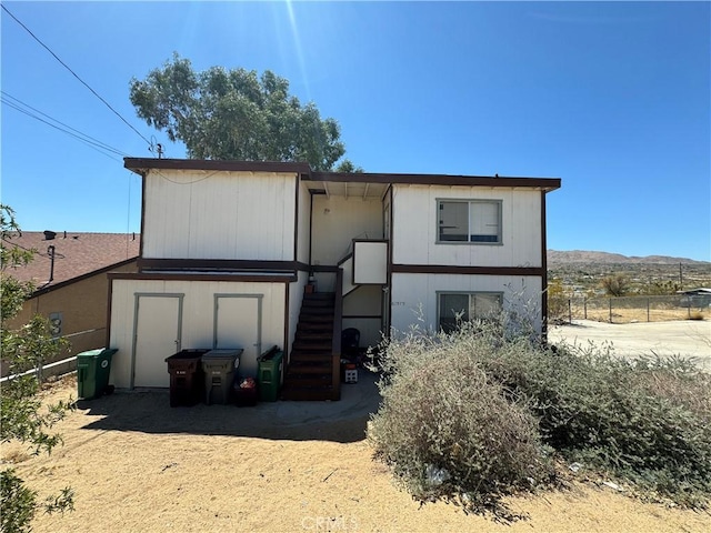 rear view of property featuring a mountain view