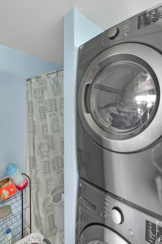 washroom with stacked washer / drying machine